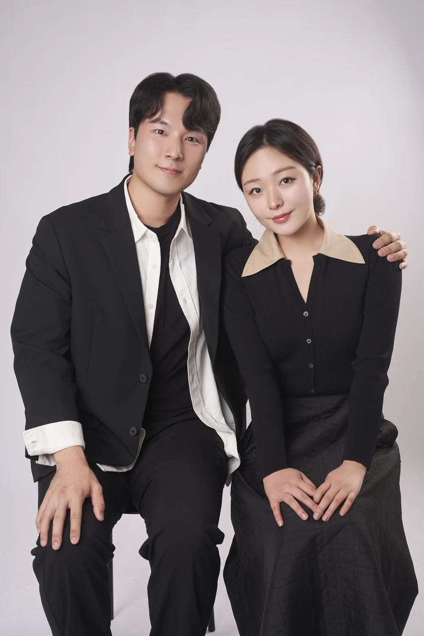 정장과 단정한 포즈로 함께 앉아 촬영한 2인 화보